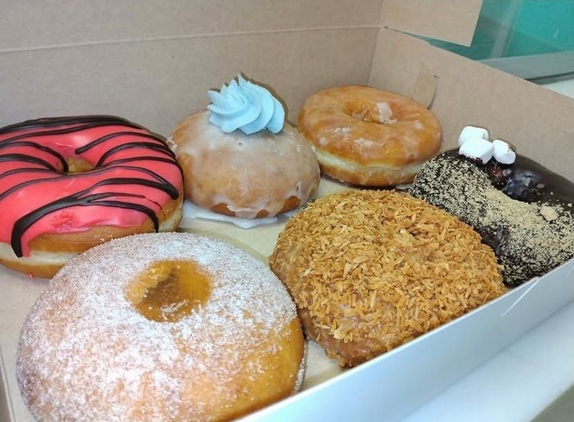 A box of Sweet Nana's donuts - strawberry iced, cream filled, glazed, coconut and chocolate